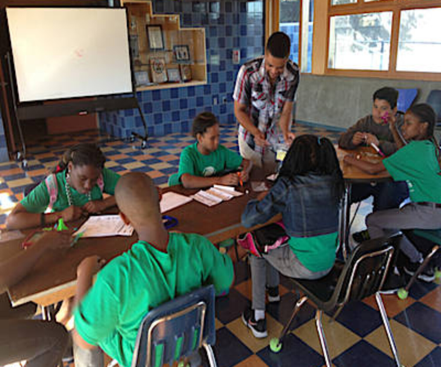PATA instructor Ryan Glymph with Challengers’ students assembling rockets